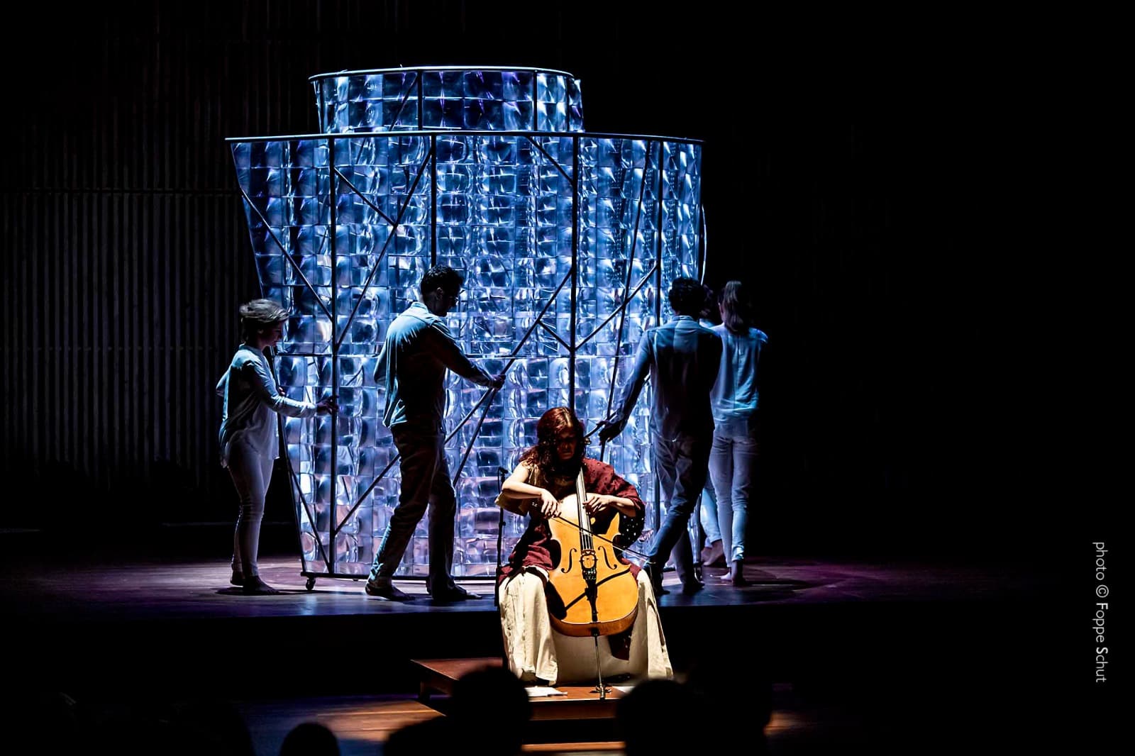 Maya plays cello in front of a glass installation which is being set in motion by the cellists of the Cello Octet Amsterdam